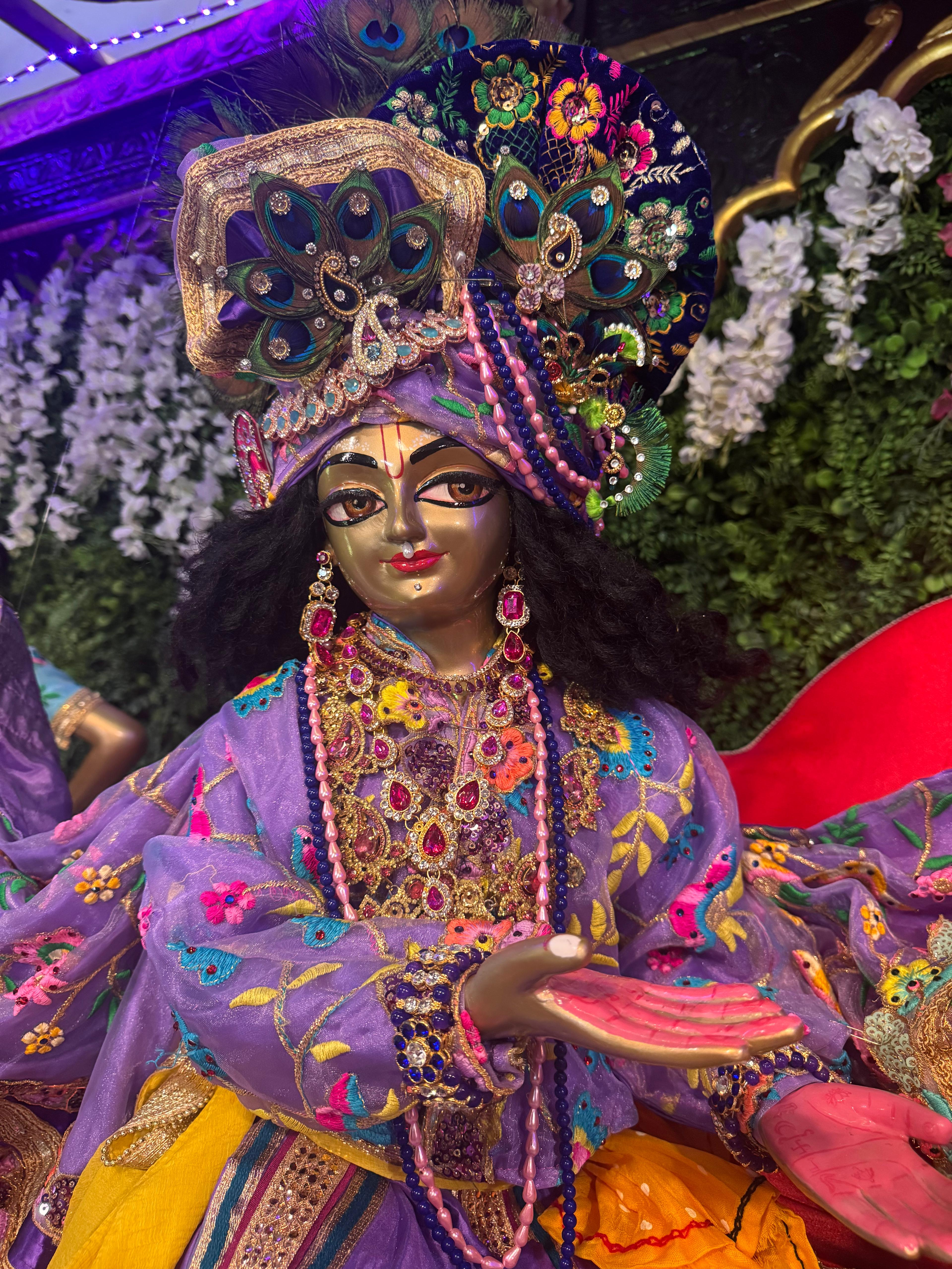 Sri Krishna adorned in exquisite sringar — peacock crown, jewels, and embroidered dress